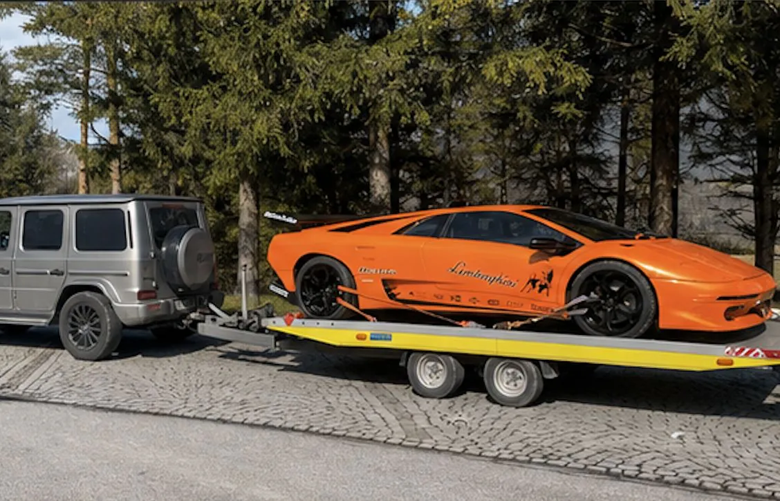 Oranger Lamborghini Diablo auf einem offenen Fahrzeuganhänger